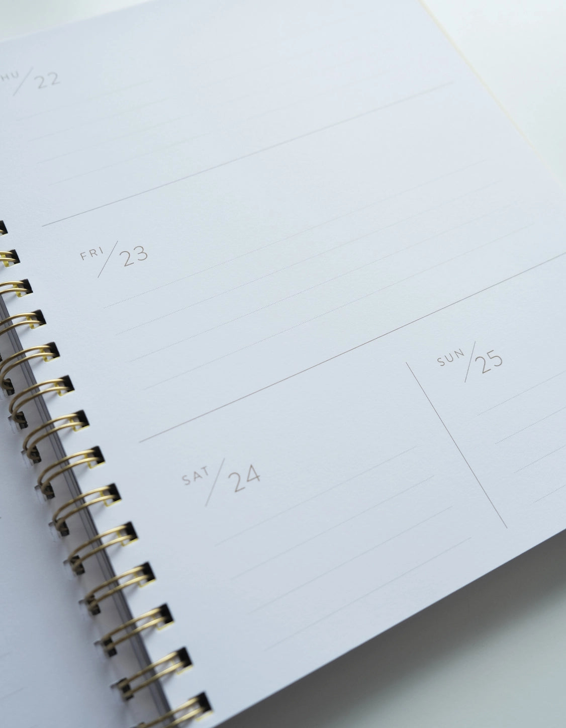 Close-up of a spiral-bound planner with a weekly layout