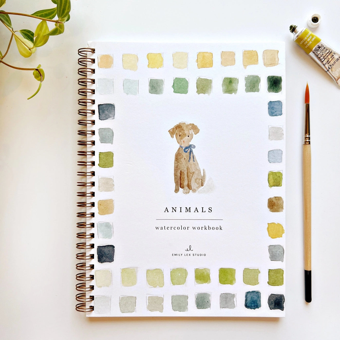 Spiral-bound watercolor workbook with white cover and a dog painting. Black text reads "animals watercolor workbook."