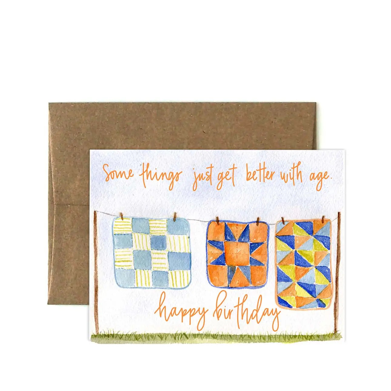 Birthday card with quilt designs and orange text 'Some things just get better with age. Happy birthday' on a white background.