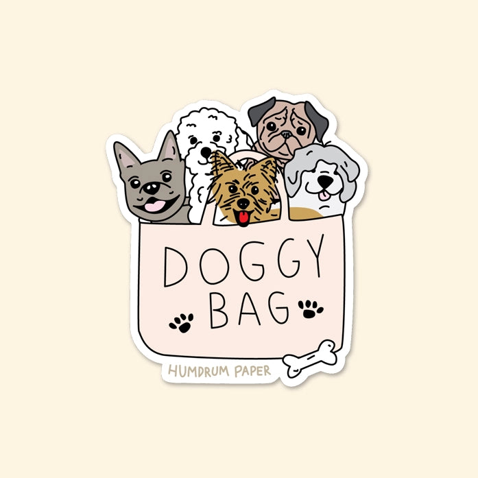 Die-cut sticker of a shopping bag filled with five dogs. Text on bag: doggy bag