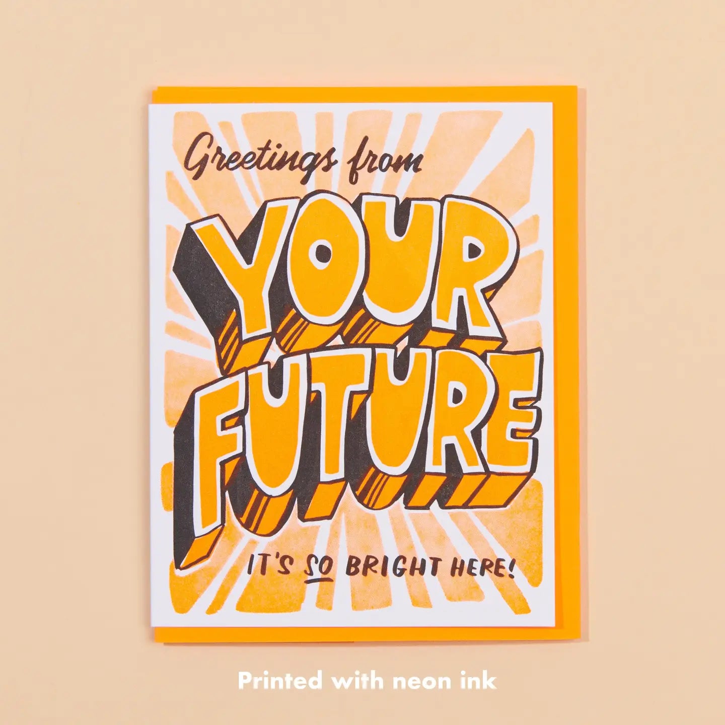 White greeting card with orange block lettering. Text: greetings from your future, it’s so bright here!