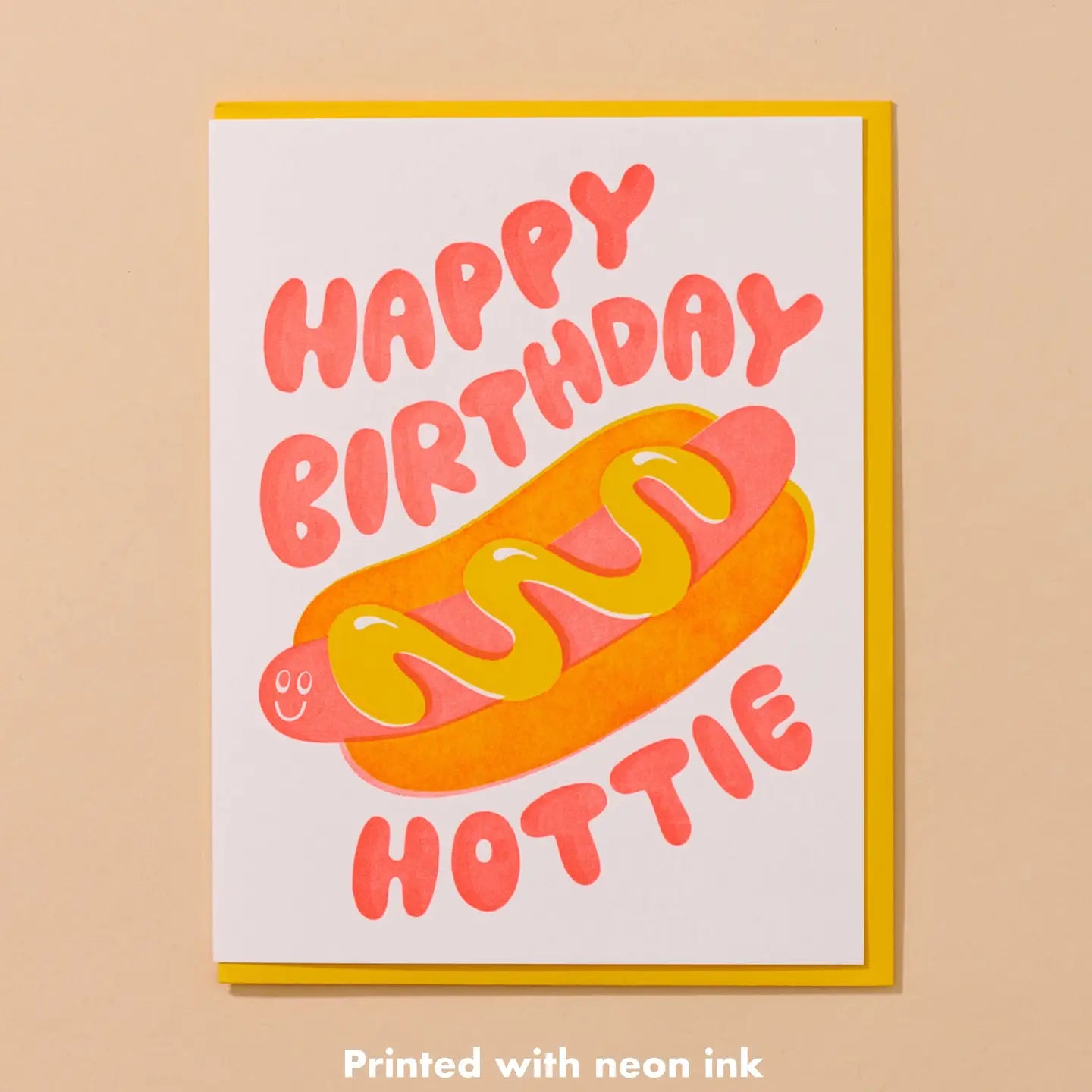 Birthday card with hot dog illustration and 'Happy Birthday Hottie' text on a beige background