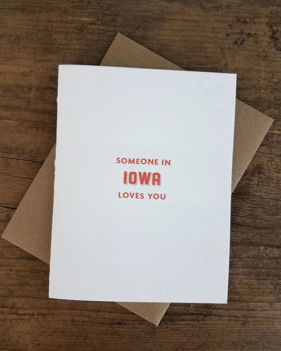 White card with red text "someone in Iowa loves you"