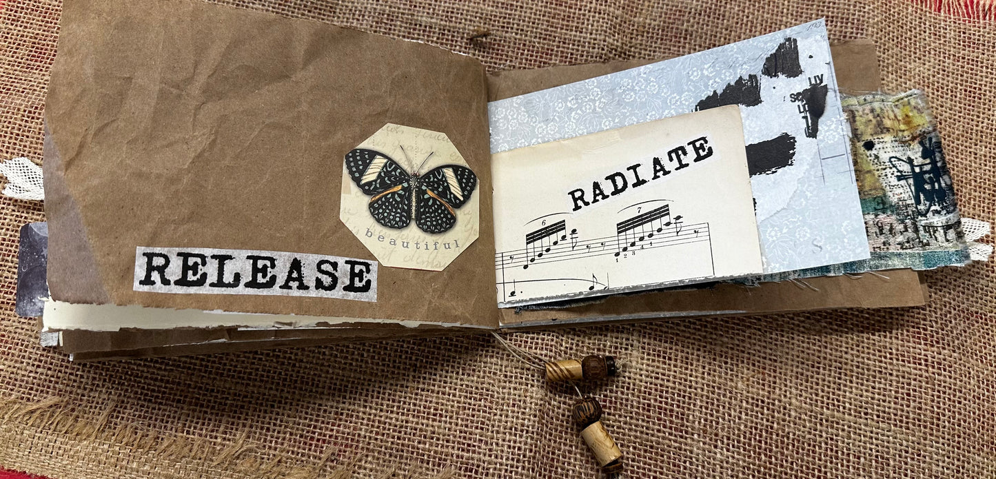 Small notebook with 'RELEASE' and butterfly design on a textured surface