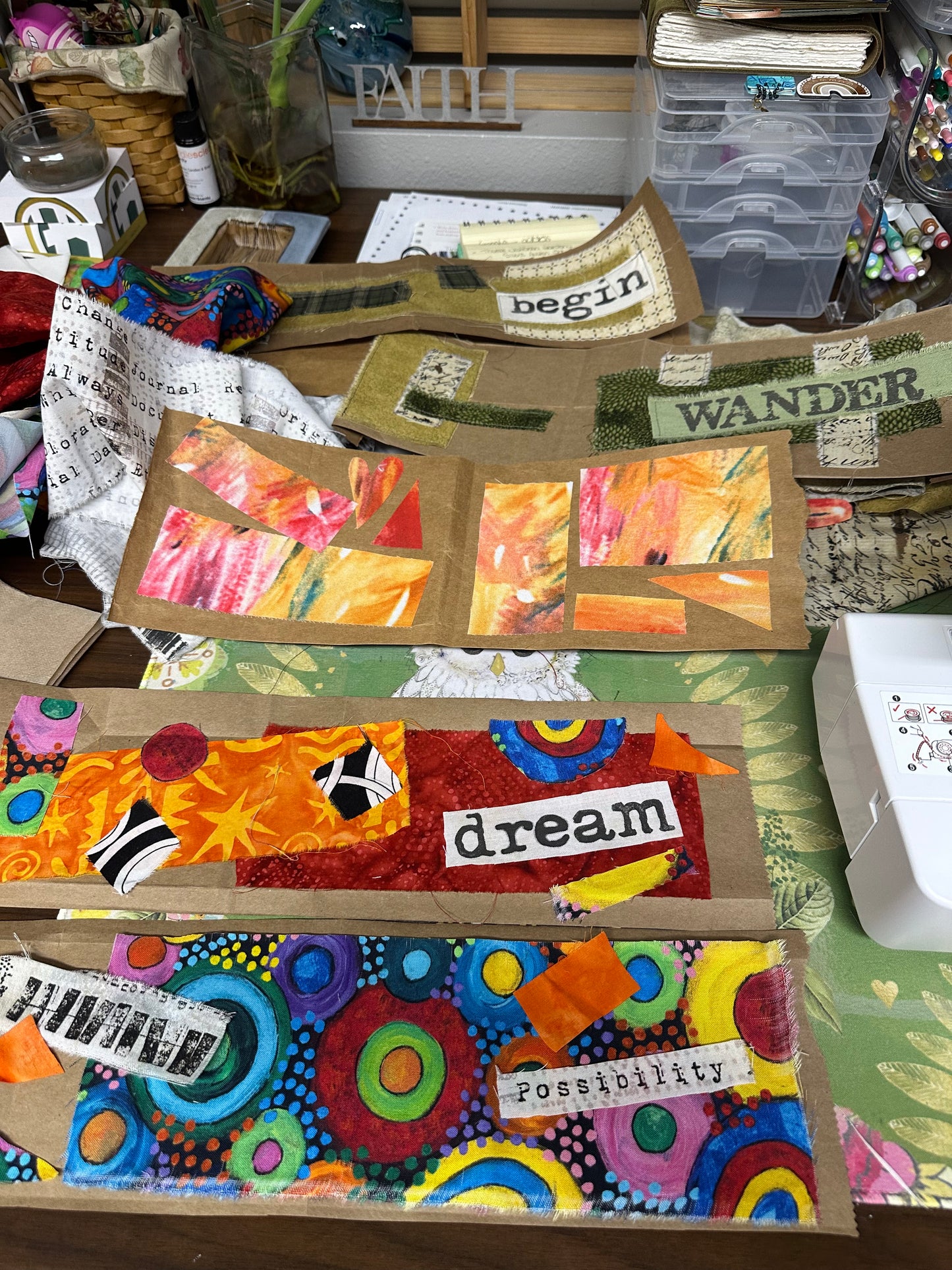 Collage of colorful art pieces with text and patterns on a textured surface.