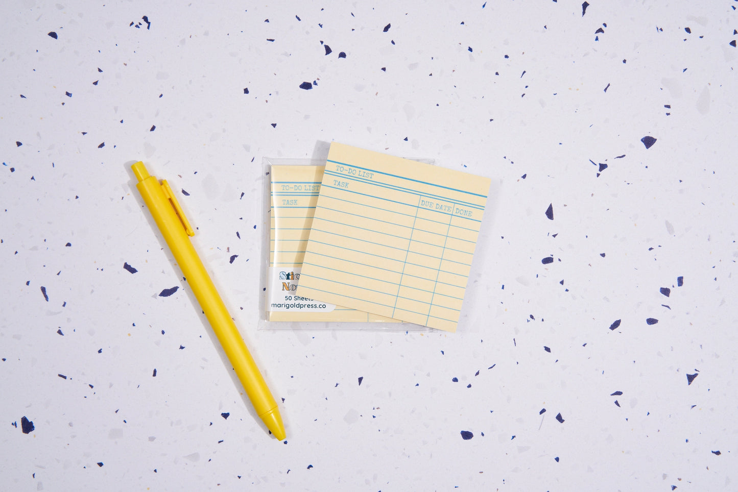 Sticky notes next to a yellow pen
