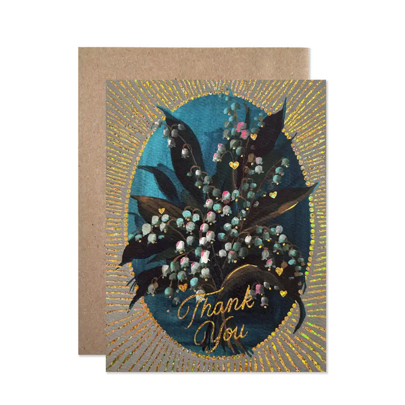 Greeting card with floral design and 'Thank You' text on a brown envelope.