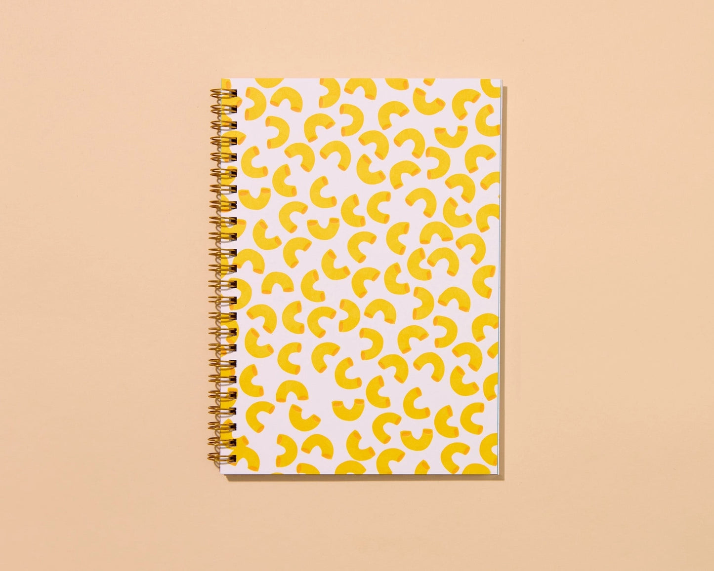 Front cover of a spiral notebook featuring yellow macaroni pattern