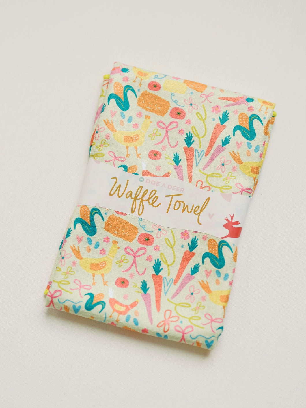 Waffle towel with colorful spring farm pattern on a white background
