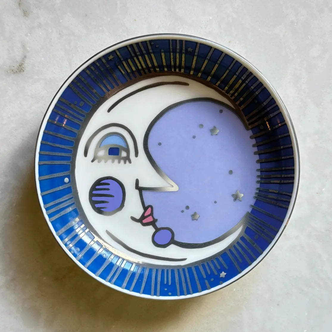Decorative trinket dish with a moon face design