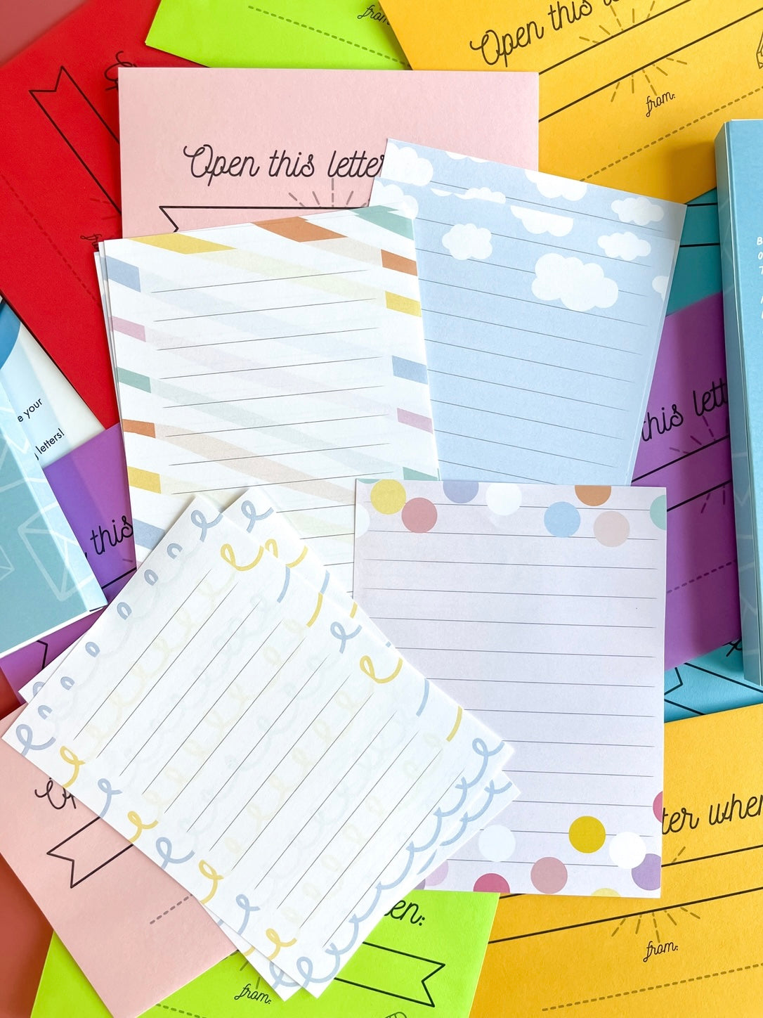 Colorful stationery items including paper and envelopes with various designs.