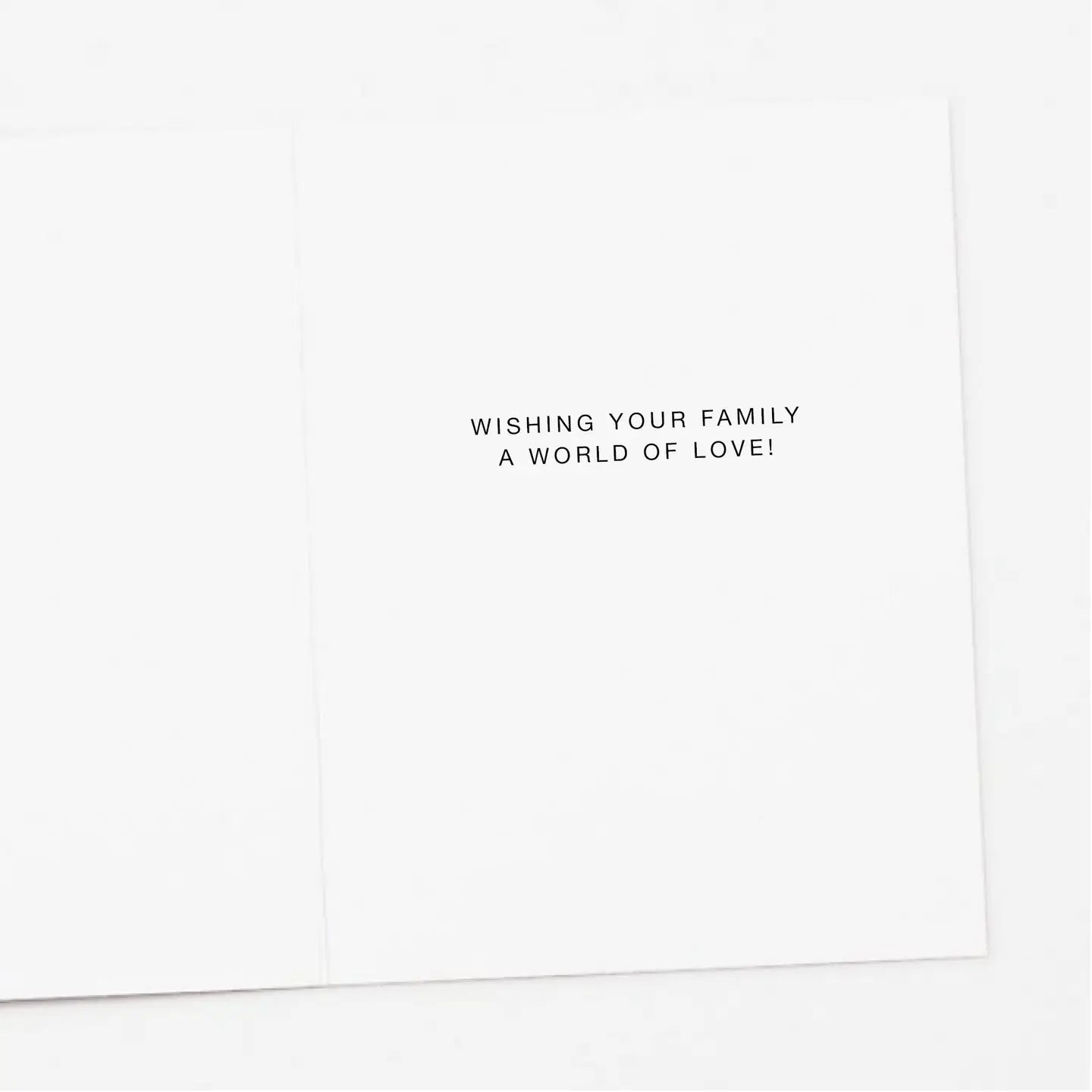Interior of card with black text 'Wishing your family a world of love!'
