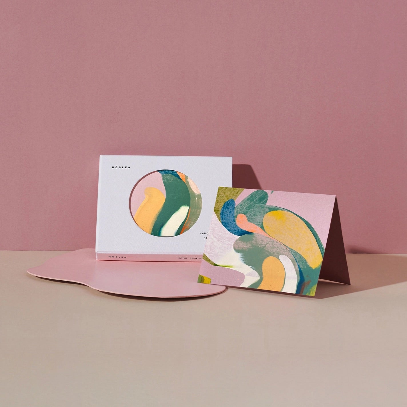 Folded card in front of boxed set of cards