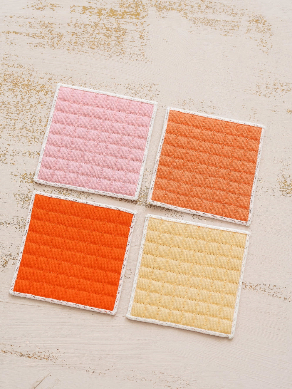 Back of coasters: pink, orange, red, and yellow