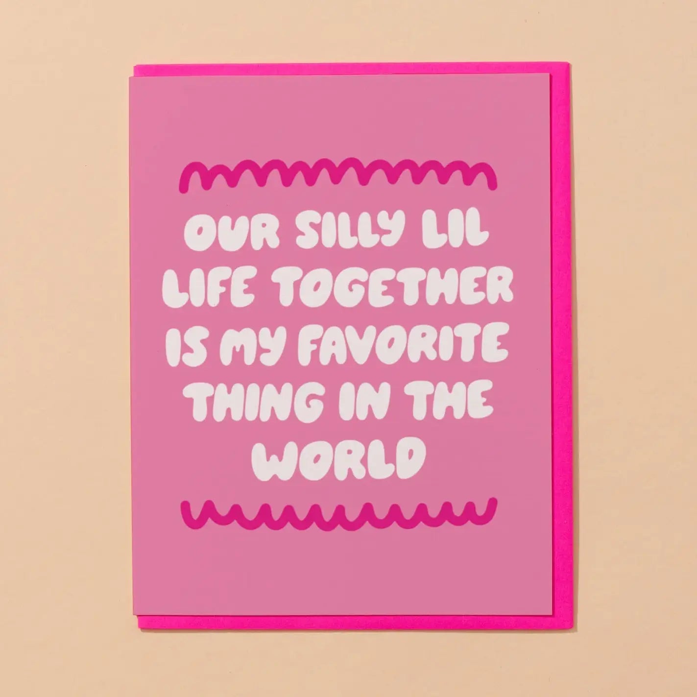 Pink card with white text on a beige background