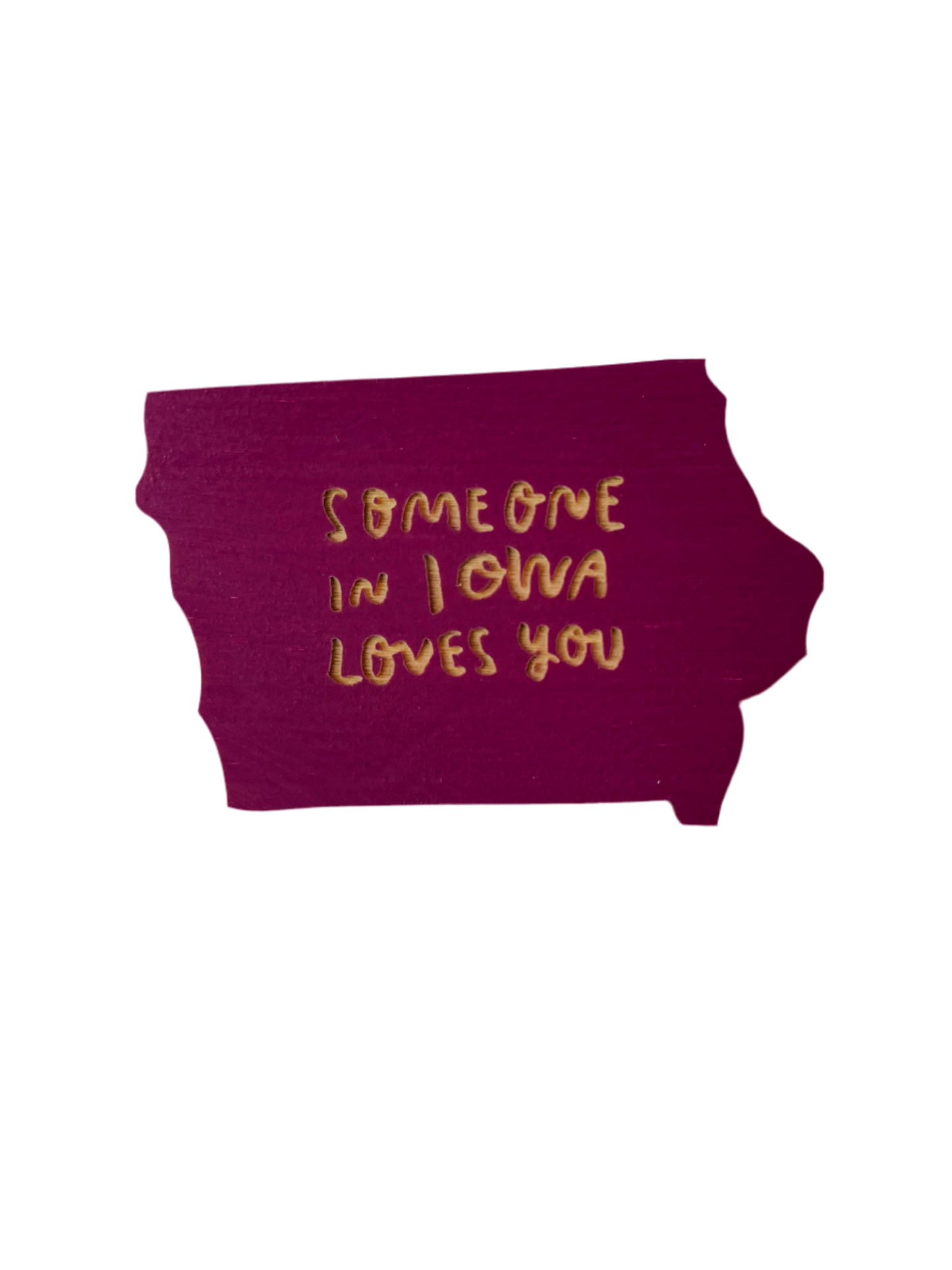 Iowa shaped purple magnet. Laser cut into the magnet is the text “someone in Iowa loves you”