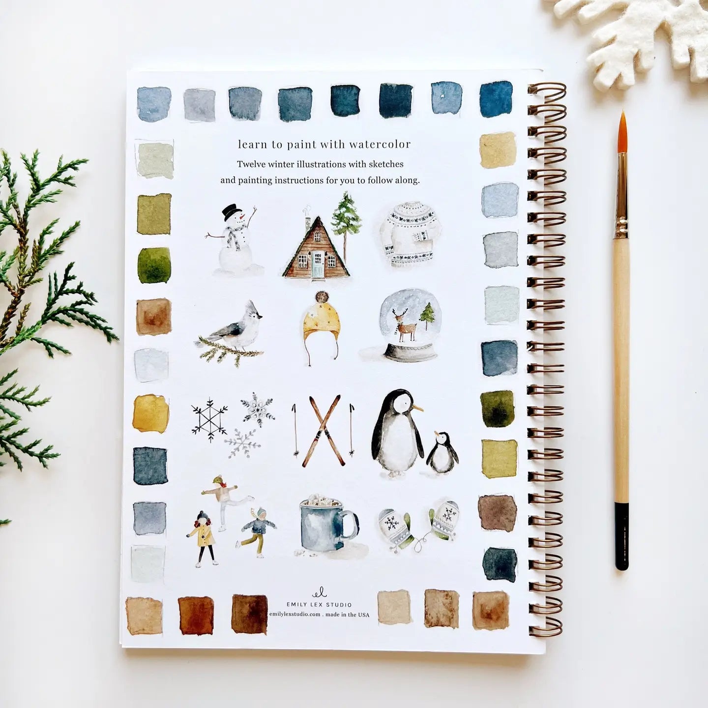 Back cover of watercolor workbook showing 12 winter painting examples