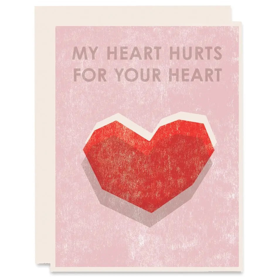 White greeting card with full color light pink background. Red heart. Tan text "my heart hurts for your heart." 