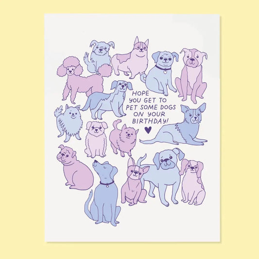 White card with illustrations of dogs in shades of purple. Purple text of “hope you get to pet some dogs on your birthday!”