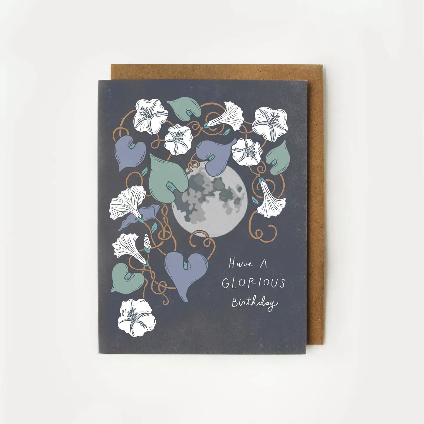 White birthday card with full color dark grey background. Illustrations of a moon and flowers. White text “have a glorious birthday”