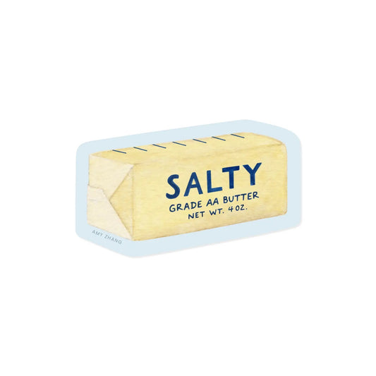 Die-cut sticker in the shape of a stick of butter. Light blue background with yellow butter illustration. Navy text reads "salty" 