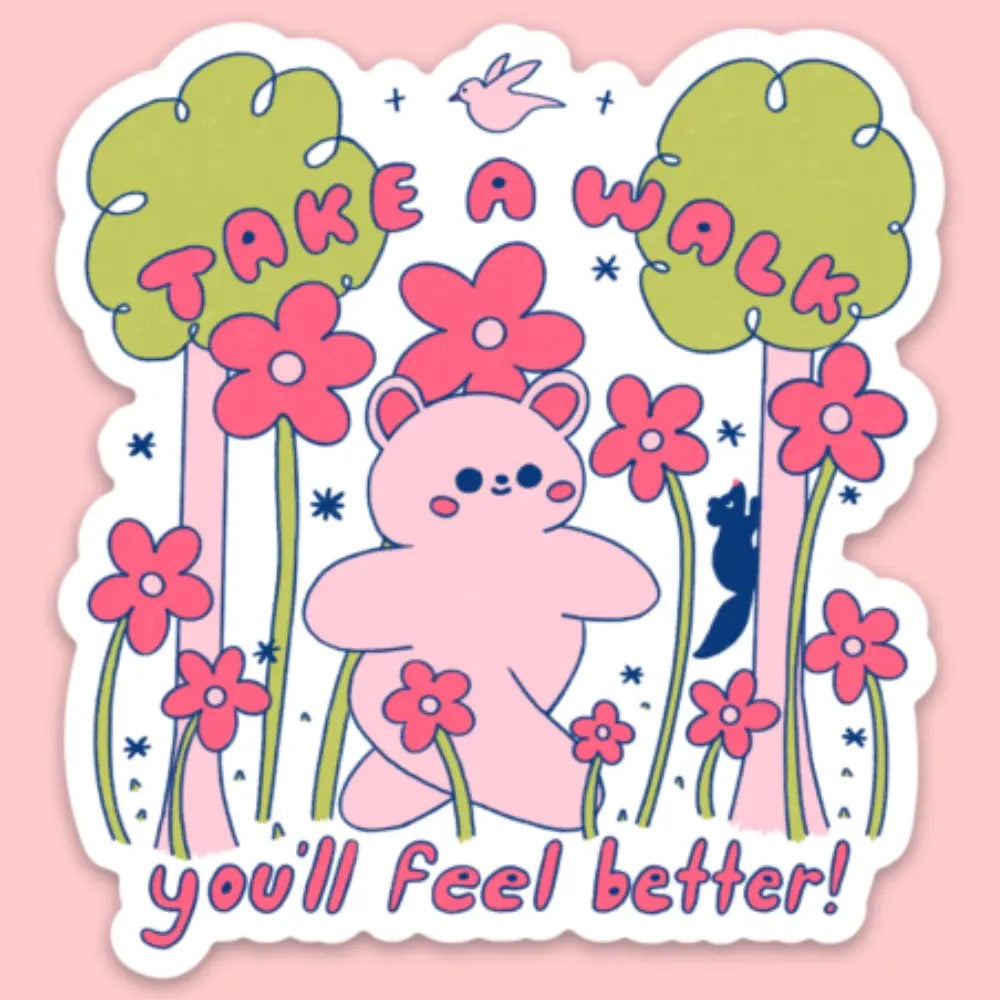 Die-cut sticker with white background. Illustration of a pink bear walking through flowers and in-between trees. Pink lettering reads "take a walk you'll feel better!" 