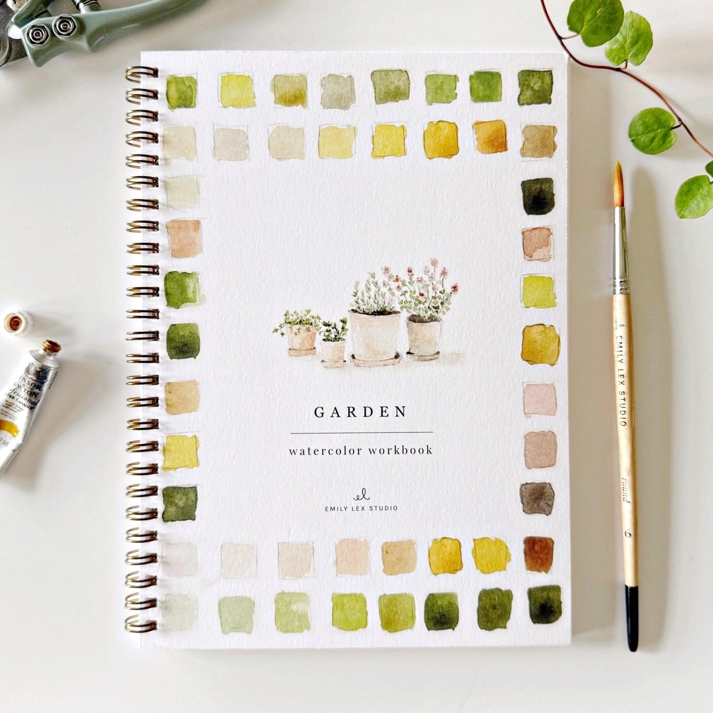 Spiral bound watercolor workbook with garden painting on front cover 