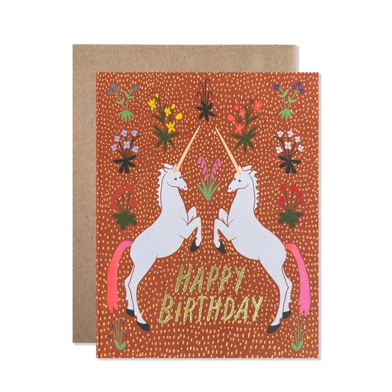 White card with full color orange and gold background. Illustrations of flowers and two white unicorns facing each other. "Happy birthday" in gold foil text. 