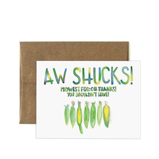 White greeting card with yellow and green watercolor painting of corn. Text reads “Aw shucks! Midwest for: oh thanks you should have!”