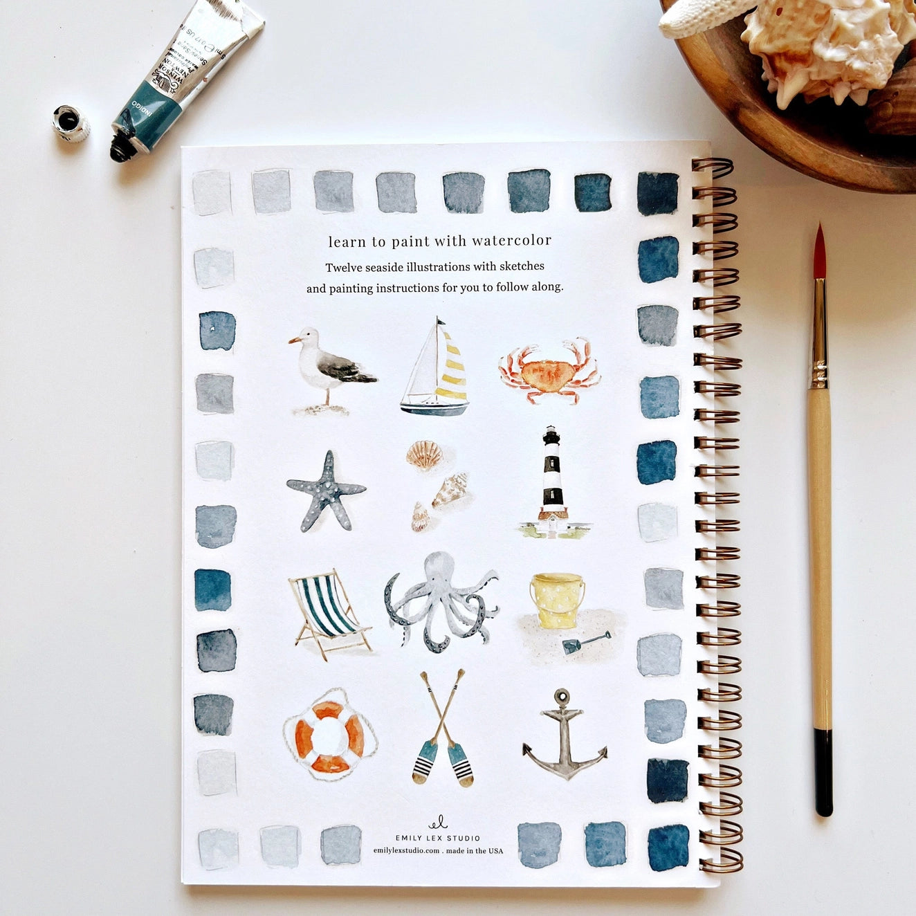 Back cover of watercolor workbook with twelve different watercolor paintings 