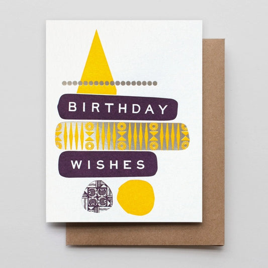 White card with abstract purple, yellow, and silver design. Text “birthday wishes”