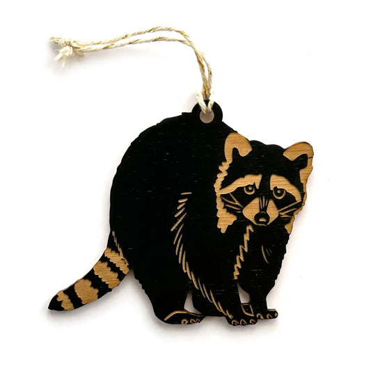 Raccoon shaped wooden ornament hanging from baker’s twine