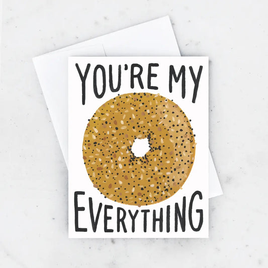 White greeting card with everything bagel illustration. Black text "you're my everything" 