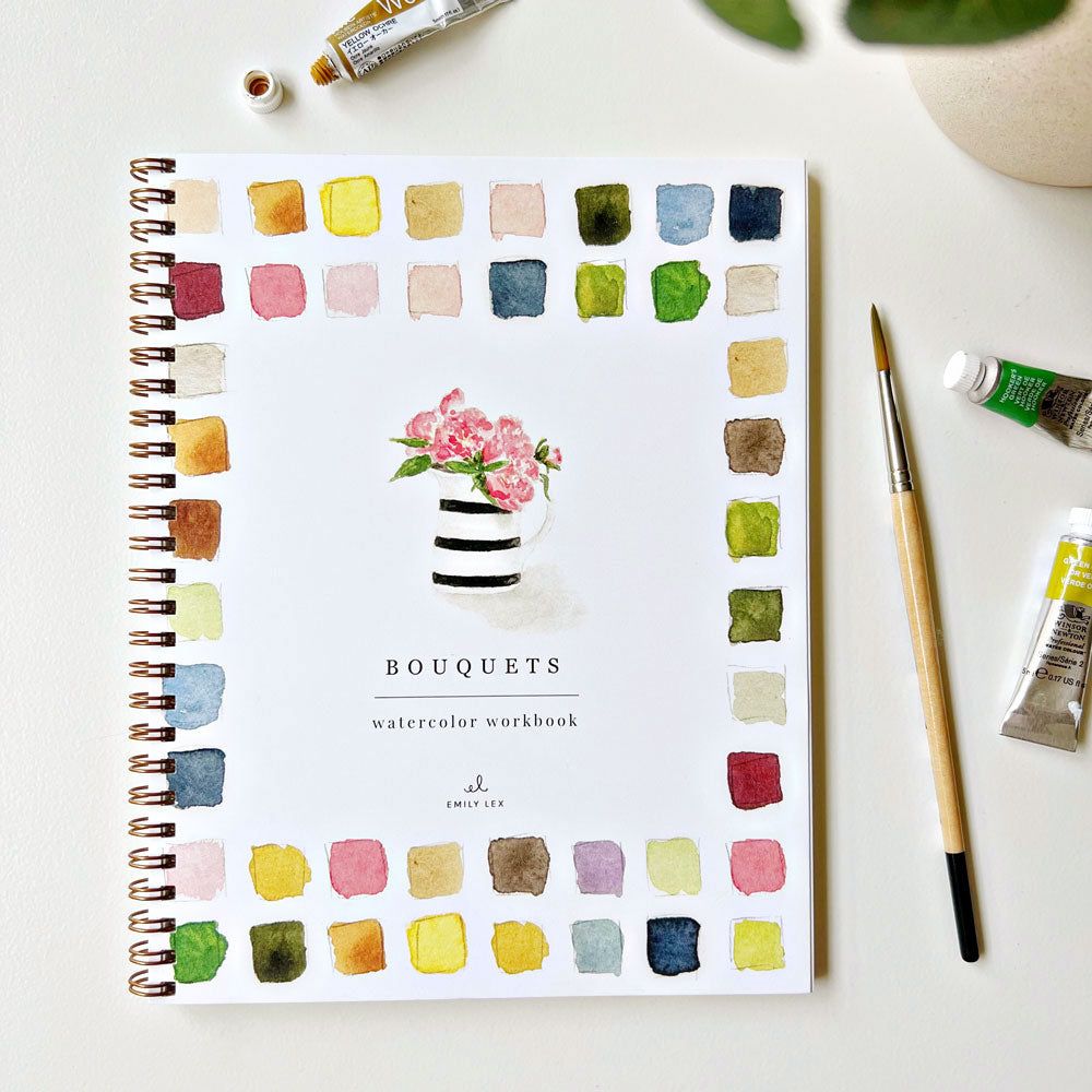 Spiral-bound watercolor workbook with white cover and a floral bouquet painting. Black text reads "bouquets watercolor workbook." 