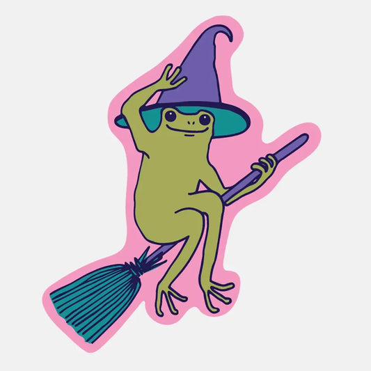 Die-cut sticker in the shape of a frog on a broomstick. Pink background. Green frog wearing a purple witch hat. 