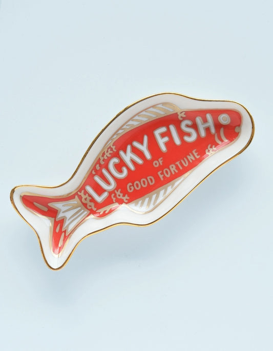 Fish shaped ceramic dish. White background with red fish painted inside. White text reads "lucky fish of good fortune" 