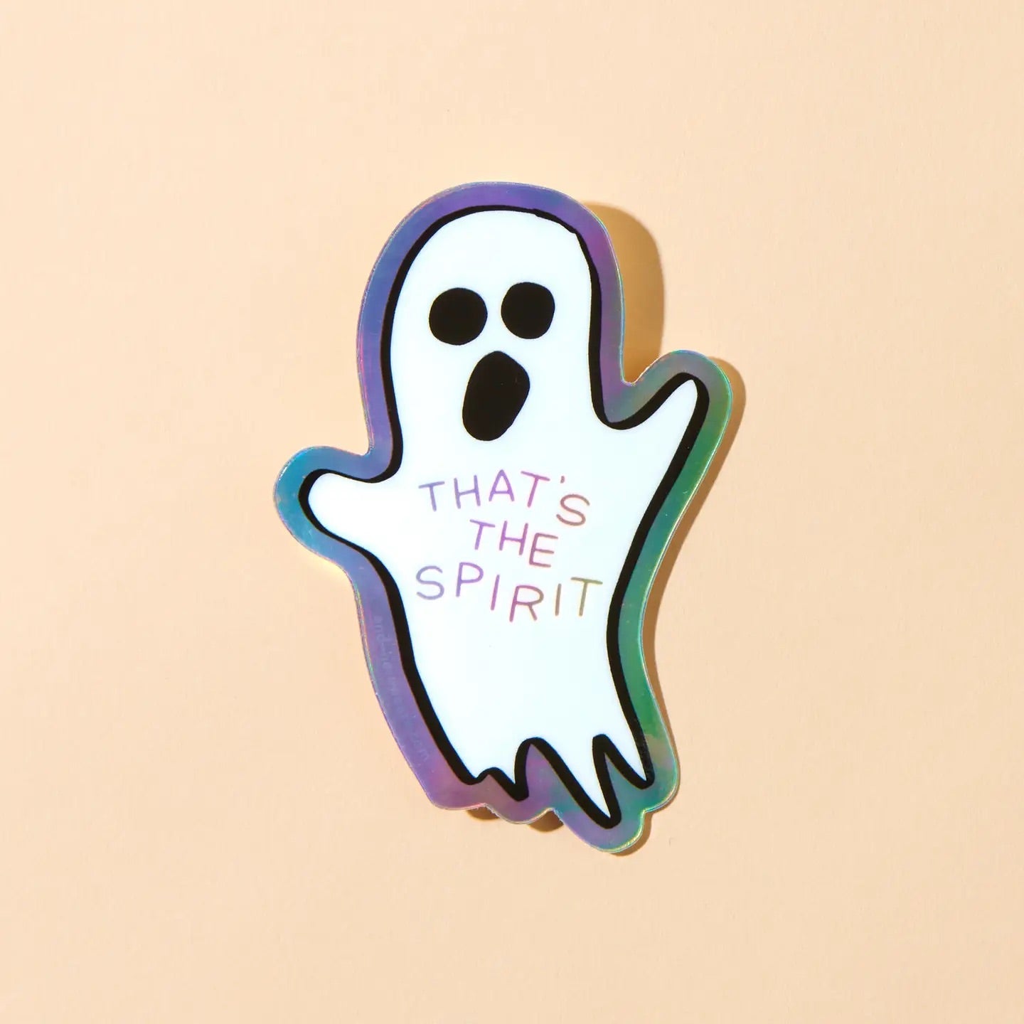 Die-cut holographic sticker in the shape of a ghost. "that's the spirit" in holographic text