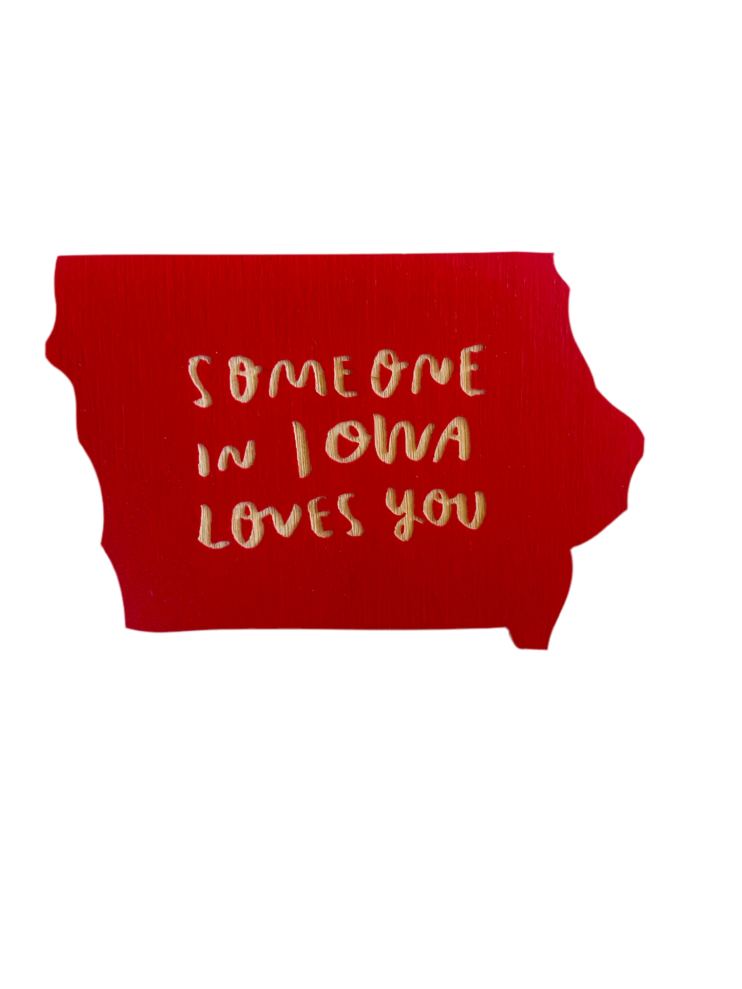 Iowa shaped red magnet. Laser cut into the magnet is the text “someone in Iowa loves you” 