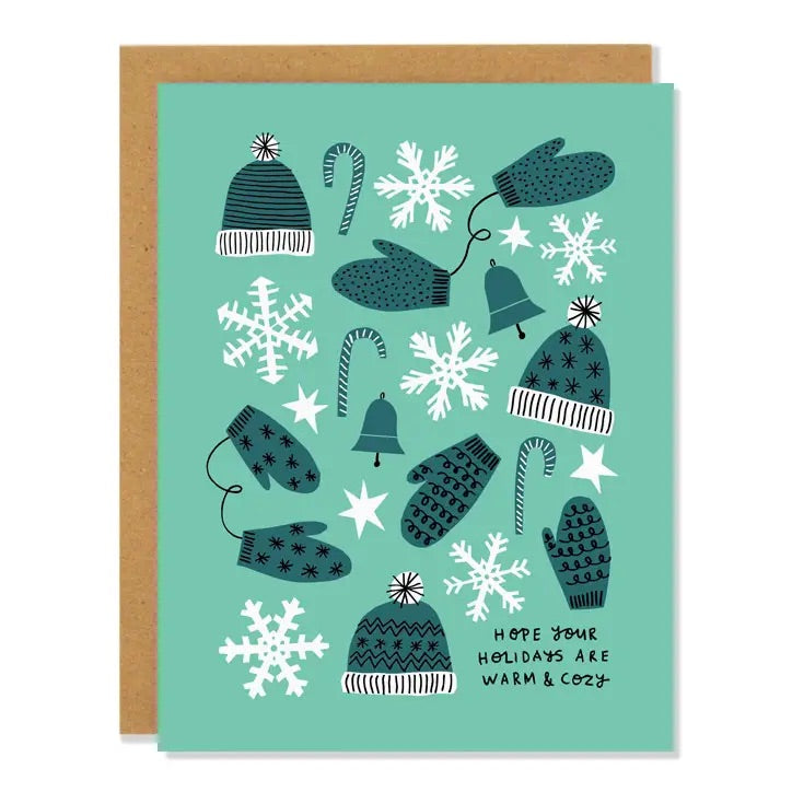 White card with full color mint background. Green and white illustrations of mittens and hats. Black text “hope your holidays are warm & cozy”