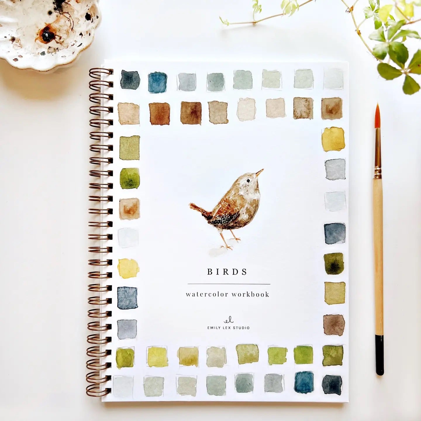 Spiral-bound watercolor workbook with white cover and a painting of a bird. Black text reads "birds watercolor workbook." 