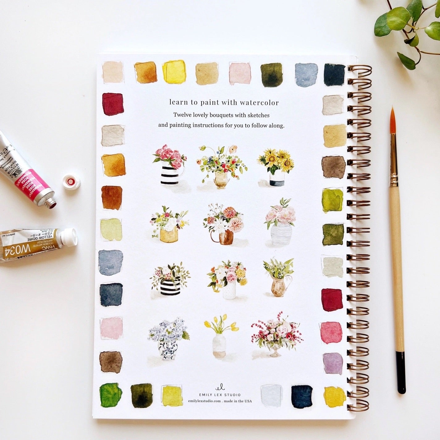 Back cover view of watercolor workbook with floral bouquet paintings. 