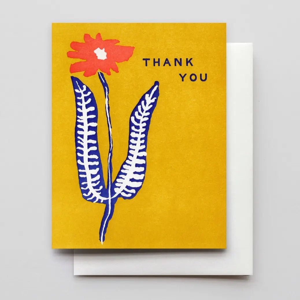 White card with a mustard yellow background. Red, navy, and white flower illustration. "Thank you" in navy text