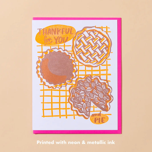 White card with neon orange and brown illustrations of pie. Brown text “thankful for you and pie”