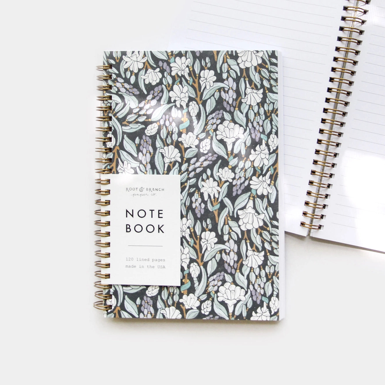 Front cover of a spiral notebook. Black and white tuberose flower design on the cover 