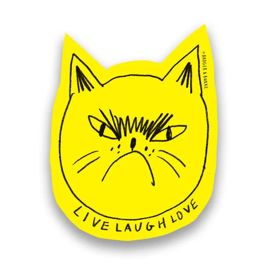 Die-cut yellow sticker in the shape of a cat face. Showing cat. Black text “live laugh love”