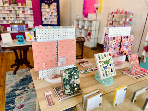 Table with notebooks and greeting cards 