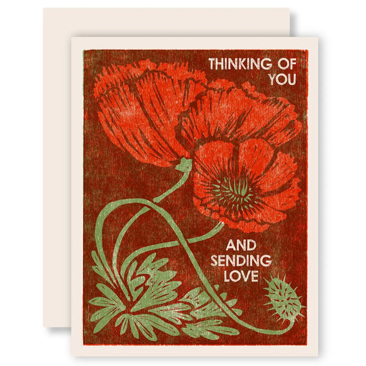 White greeting card with full color dark red background. Poppy design. White text "thinking of you and sending love" 