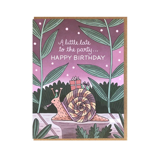 White card with purple background and an illustration of a snail with green foliage. "A little late to the party... Happy Birthday" in white text. 