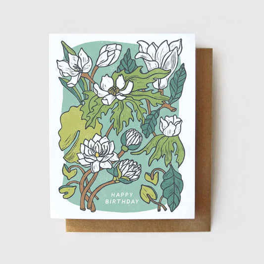 White birthday card with green, blue, and white floral illustrations. White text “happy birthday” 