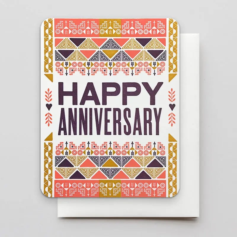 White card with red, mustard, and black triangle pattern. "Happy Anniversary" in black text